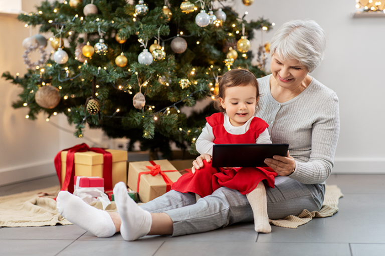 grandmother and baby girl with christmas gifts