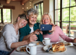 happy senior friends having coffee and cake