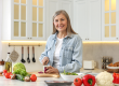 happy woman cutting onion
