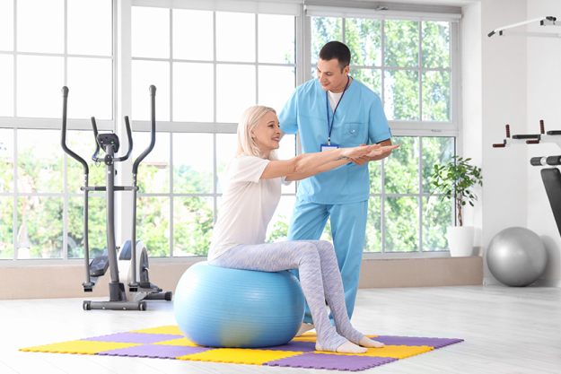 male physiotherapist working mature woman male physiotherapist working mature woman