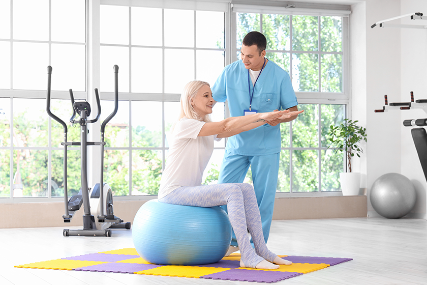 male physiotherapist working mature woman