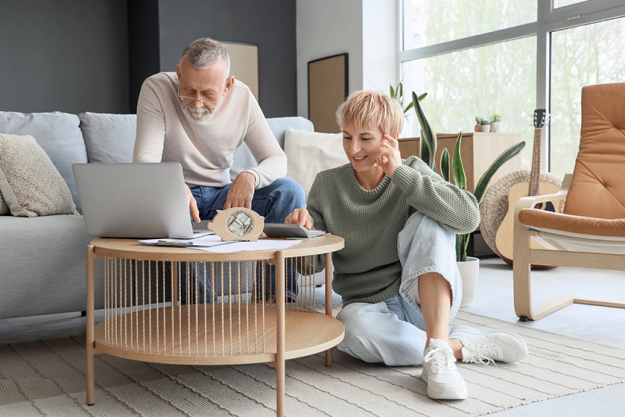 mature couple laptop counting money mature couple laptop counting money