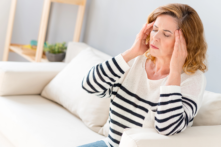 senior woman feels pain in head