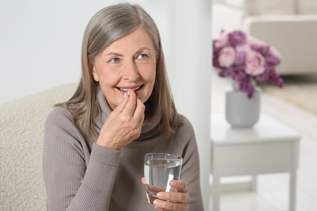 senior woman glass water taking pill senior woman glass water taking pill