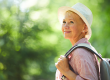 smiling mature woman hat backpack