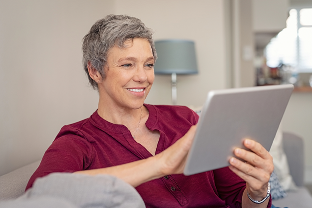 smiling senior woman looking her digital tablet