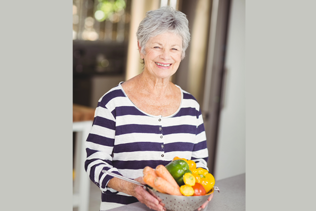 woman holding colander with vegetables woman holding colander with vegetables