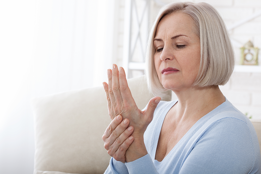 woman massaging her arthritic hand