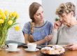Granma,And,Granddaughter,Sitting,By,The,Table,And,Watching,Old