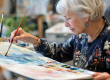 a senior woman in a watercolor painting class