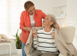 caregiver covering senior woman with blanket