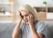 close up aged woman suffering from headache