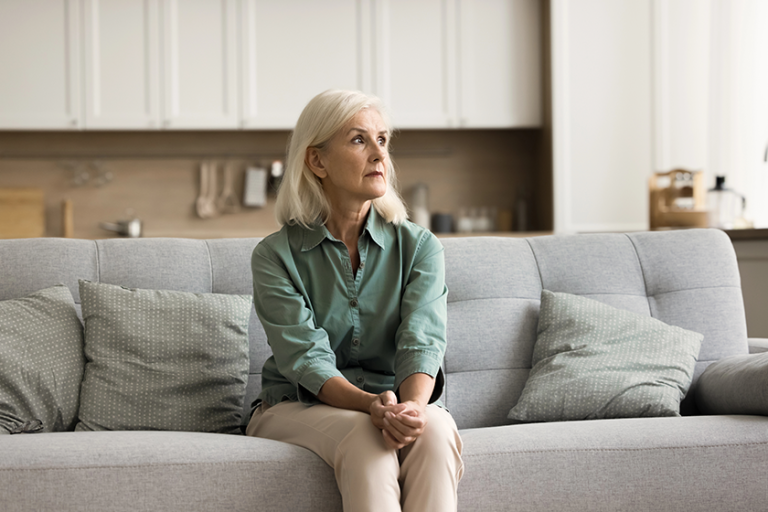 concerned blonde senior woman sitting