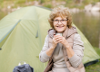 happy mature female hiker hot drink