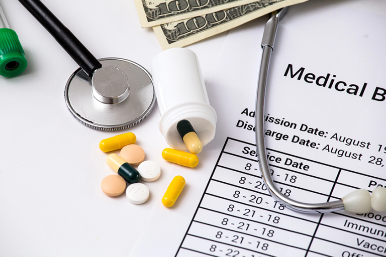 health care costs stethoscope and calculator