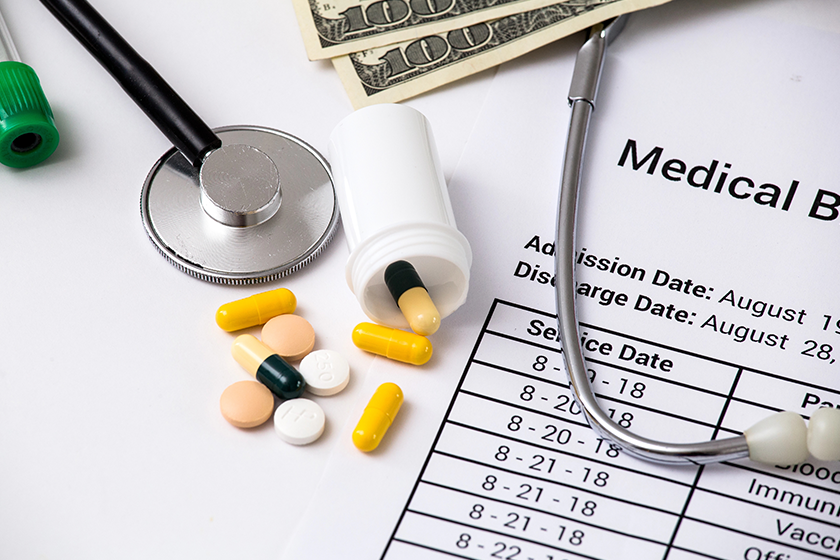 health care costs stethoscope and calculator