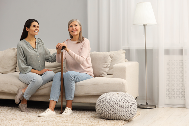 mature lady with walking cane and young woman