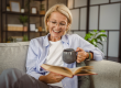 mature woman sit living room read book