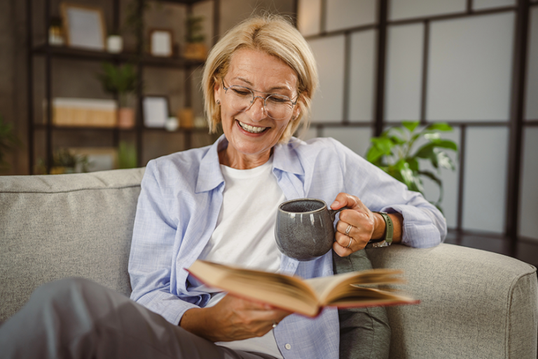 mature woman sit living room read book