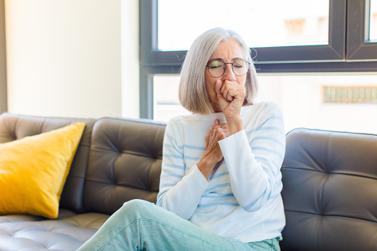 middle age pretty woman feeling ill with a sore throat