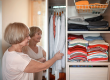 senior woman choosing outfit from wardrobe