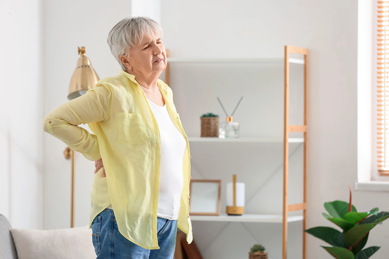 senior woman shirt suffering back pain