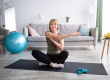 sporty senior lady sitting in lotus pose