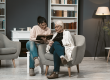 young woman reads book for her elderly mother
