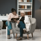 young woman reads book for her elderly mother