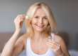 age cosmetics mature woman applying face serum